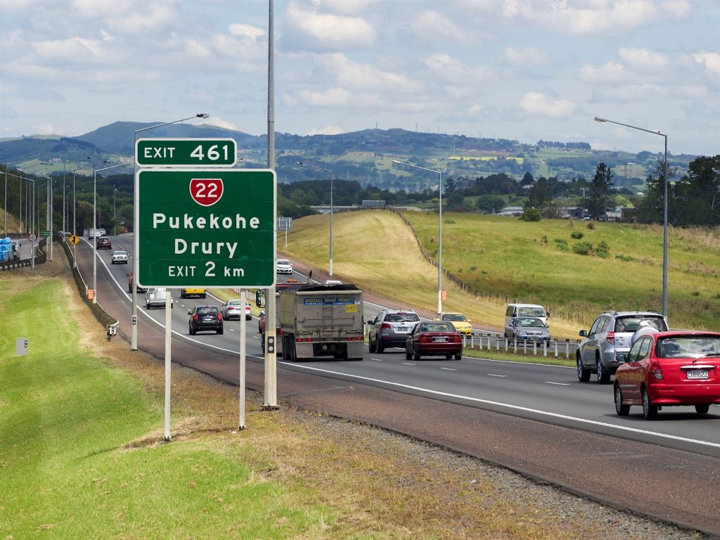Truck,Amongst,Light,Traffic,Pukekohe,Drury,Exit,Sign,Important,To,Avoid,Drowsiness.